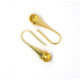 Gold-colored earrings with a honey-colored polished amber ball