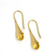 Gold-colored earrings with a honey-colored polished amber ball