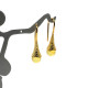 Gold-colored earrings with a honey-colored polished amber ball