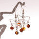 Butterfly-shaped earrings with amber pieces in baroque shape in cognac color