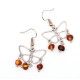Butterfly-shaped earrings with amber pieces in baroque shape in cognac color