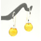 Silver earrings with a yellow amber ball